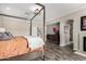 Main bedroom showcasing a four-poster bed, recessed lighting, and wood-look flooring at 7236 W Electra Ln, Peoria, AZ 85383