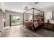 Spacious main bedroom with a four-poster bed and a private balcony with a view at 7236 W Electra Ln, Peoria, AZ 85383