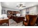 Well-appointed office with wood furniture, a ceiling fan, and plenty of storage at 7236 W Electra Ln, Peoria, AZ 85383