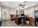 Functional office with an executive desk, wingback chairs, and shuttered window at 7236 W Electra Ln, Peoria, AZ 85383