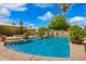 Inviting pool area with a unique stone water feature and lush tropical foliage at 7236 W Electra Ln, Peoria, AZ 85383