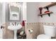 A powder room with decorative tiles, a pedestal sink, and an updated faucet at 7236 W Electra Ln, Peoria, AZ 85383