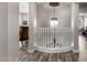 Elegant staircase with white railings, wood floors, and a decorative chandelier creating a focal point at 7236 W Electra Ln, Peoria, AZ 85383