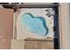 Aerial view of a residential pool featuring a unique shape and a lounging area with outdoor seating at 724 N Pine St, Gilbert, AZ 85233