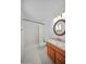 Well-lit bathroom with walk-in shower, wood vanity, and neutral color palette at 724 N Pine St, Gilbert, AZ 85233