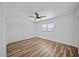 Bright bedroom with a ceiling fan, closet, and wood-look vinyl flooring at 724 N Pine St, Gilbert, AZ 85233