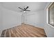 Bright bedroom with a ceiling fan, closet, and wood-look vinyl flooring at 724 N Pine St, Gilbert, AZ 85233