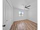 Bright bedroom with a ceiling fan, closet, and wood-look vinyl flooring at 724 N Pine St, Gilbert, AZ 85233