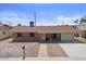 Inviting single story home with brick exterior, covered porch, and well-manicured front yard at 724 N Pine St, Gilbert, AZ 85233