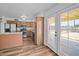 Updated kitchen featuring stainless steel appliances, wood cabinets, a center island, and patio doors at 724 N Pine St, Gilbert, AZ 85233