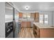 Well-lit kitchen with stainless steel appliances, wood cabinets, and center island at 724 N Pine St, Gilbert, AZ 85233