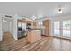 Well-lit kitchen boasts stainless steel appliances, wood cabinets, and a center island at 724 N Pine St, Gilbert, AZ 85233