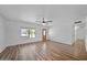 Bright living room offers lovely floors, neutral walls, a fan, and many windows at 724 N Pine St, Gilbert, AZ 85233