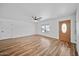 Bright living room features beautiful wood-look floors, a ceiling fan, and lots of natural light at 724 N Pine St, Gilbert, AZ 85233