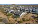 An aerial view shows a home with a fenced-in backyard, patio furniture and desert landscaping in a housing community at 8040 E Jaeger St, Mesa, AZ 85207