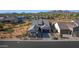 Expansive aerial view of a modern home with desert landscaping, a paved driveway, and views of the surrounding mountains at 8040 E Jaeger St, Mesa, AZ 85207