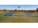 Outdoor basketball court featuring a hoop and colorful playing surface surrounded by landscaping and a fence at 8040 E Jaeger St, Mesa, AZ 85207