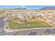 Aerial view of neighborhood park with green grass, playground, ramada and mountain views in the distance at 8040 E Jaeger St, Mesa, AZ 85207
