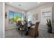 Bright dining room with large windows, neutral paint, and views of the backyard at 8040 E Jaeger St, Mesa, AZ 85207