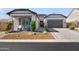 Charming single-story home boasts a desert landscape, stone accents, and a spacious two-car garage at 8040 E Jaeger St, Mesa, AZ 85207