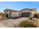 A well-maintained single-story home featuring desert landscaping and a spacious two-car garage at 8040 E Jaeger St, Mesa, AZ 85207