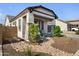 Charming single-story home showcasing desert landscaping with decorative rock and stone accents at 8040 E Jaeger St, Mesa, AZ 85207