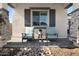 Inviting covered porch with comfortable seating, stone columns, and gray accents at 8040 E Jaeger St, Mesa, AZ 85207