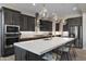 Gourmet kitchen with quartz counters, stainless appliances, and elegant pendant lighting at 8040 E Jaeger St, Mesa, AZ 85207