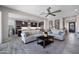 Open-concept living room featuring wood-look tile flooring and flows into a modern kitchen at 8040 E Jaeger St, Mesa, AZ 85207