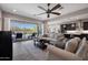 Bright living space features comfortable sofas, large sliding glass doors, and views of the outdoor pool at 8040 E Jaeger St, Mesa, AZ 85207