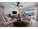 Living room with tile floors, modern furnishings, and large sliding doors that open to the backyard oasis at 8040 E Jaeger St, Mesa, AZ 85207