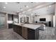 Open-concept living area with a view of the kitchen island and comfortable seating area at 8040 E Jaeger St, Mesa, AZ 85207