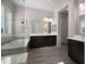 Main bathroom with standalone soaking tub, glass shower, and double vanity in a calming color scheme at 8040 E Jaeger St, Mesa, AZ 85207