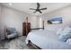 Spacious main bedroom with four-poster bed, wooden furniture, ceiling fan and calm wall art at 8040 E Jaeger St, Mesa, AZ 85207