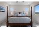 Bright main bedroom featuring a wooden four-poster bed, side tables and scenic wall art at 8040 E Jaeger St, Mesa, AZ 85207