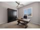Bright home office with a built-in murphy bed, custom desk and a ceiling fan that provides ample light and comfort at 8040 E Jaeger St, Mesa, AZ 85207
