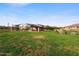 A view of a park with open green space, a covered seating area and playground in a residential community at 8040 E Jaeger St, Mesa, AZ 85207