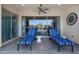 Inviting covered patio with comfortable lounge chairs and a ceiling fan, perfect for relaxing outdoors at 8040 E Jaeger St, Mesa, AZ 85207