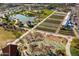 Aerial view of a lake, community garden, playground, and grassy area at 9230 E Scott Ave, Mesa, AZ 85212