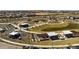 Aerial view of a park featuring a playground, concert stage, picnic areas, and grassy areas at 9230 E Scott Ave, Mesa, AZ 85212
