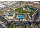Scenic aerial view of a community park, showcasing lush green spaces, a serene pond, and walking trails at 9230 E Scott Ave, Mesa, AZ 85212