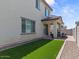 Private backyard featuring artificial turf, a covered patio, and a gravel border at 9230 E Scott Ave, Mesa, AZ 85212