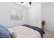 Comfortable bedroom with a soft bed, sliding door closet, and a large window for ample light at 9230 E Scott Ave, Mesa, AZ 85212