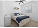 Cozy bedroom with plush bedding, a decorative shelf, and natural light from the window at 9230 E Scott Ave, Mesa, AZ 85212