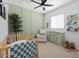 Charming Bedroom with soft colors, cozy crib, comfortable seating, and playful decor for a warm atmosphere at 9230 E Scott Ave, Mesa, AZ 85212