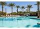 Inviting community pool with sparkling water, surrounded by palm trees and comfortable lounge seating at 9230 E Scott Ave, Mesa, AZ 85212