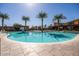 Stunning community pool area surrounded by mature palm trees, lounge chairs, and a basketball hoop, perfect for relaxation at 9230 E Scott Ave, Mesa, AZ 85212