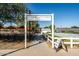 Inviting Steadfast Farm entrance, featuring a charming sign, pathway, and views of the garden and outdoor seating area at 9230 E Scott Ave, Mesa, AZ 85212