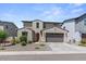 Inviting home exterior with a two-car garage, complemented by desert landscaping at 9230 E Scott Ave, Mesa, AZ 85212