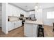 Modern kitchen features white cabinets, stainless steel appliances, and eat-in island seating at 9230 E Scott Ave, Mesa, AZ 85212